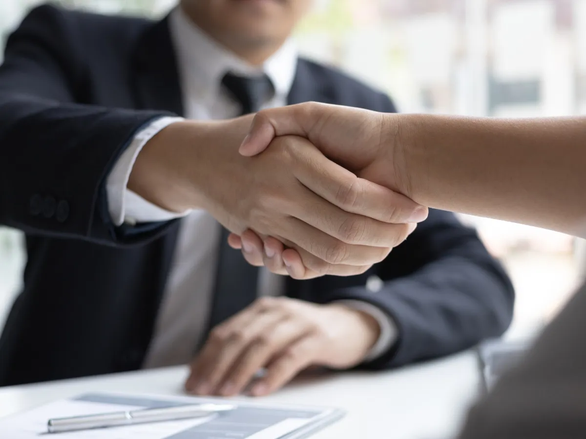 Two men shaking hands as they agree to employement